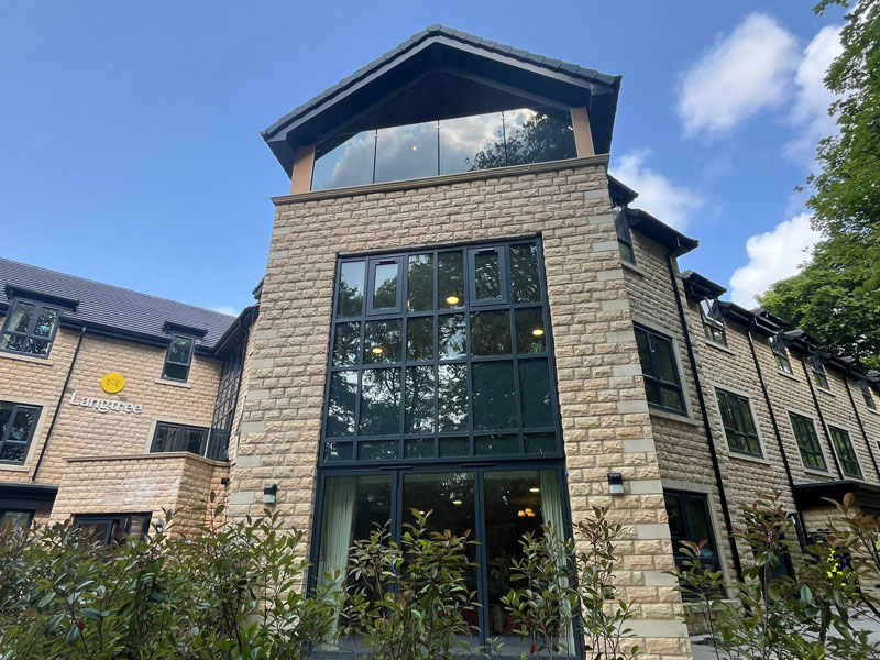 Contemporary stone-clad commercial building showcasing successful land development and architectural planning.